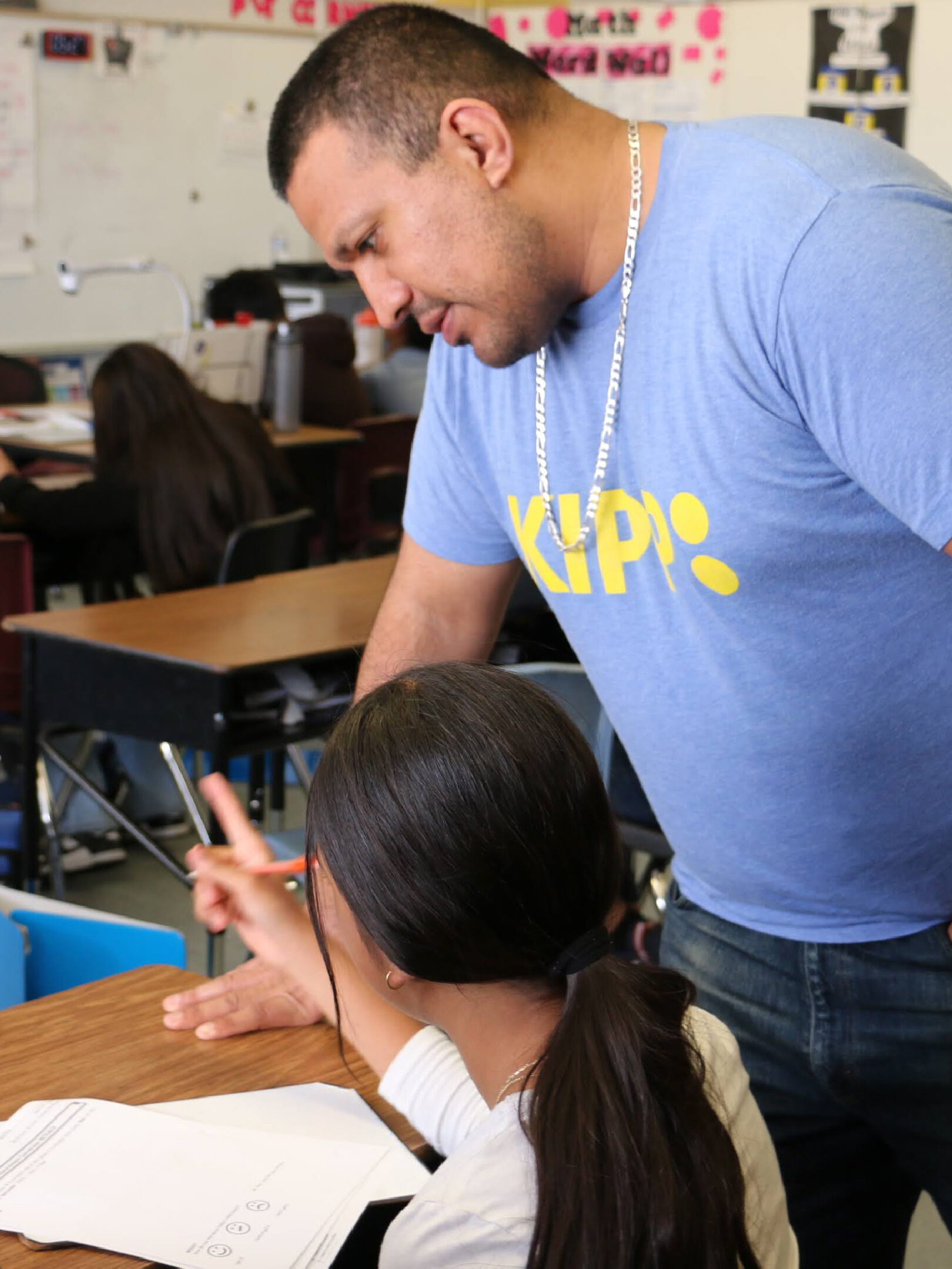 Teacher with student in classroom